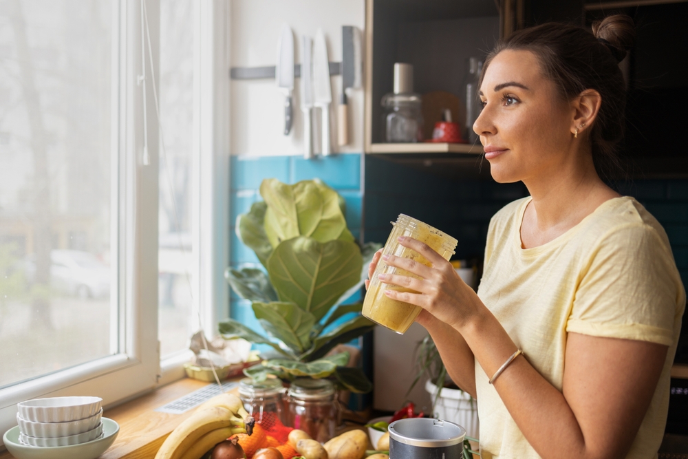 Woman drinking water and being healthy to prevent leg cramps from varicose veins in Los Angeles, CA